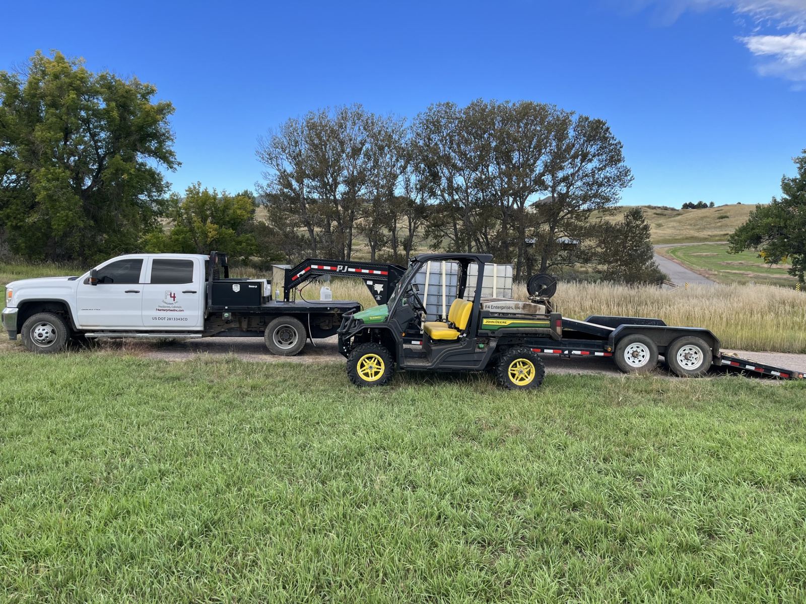 The F4 Enterprises truck and John Deere Gator sprayer on a Colorado pasture